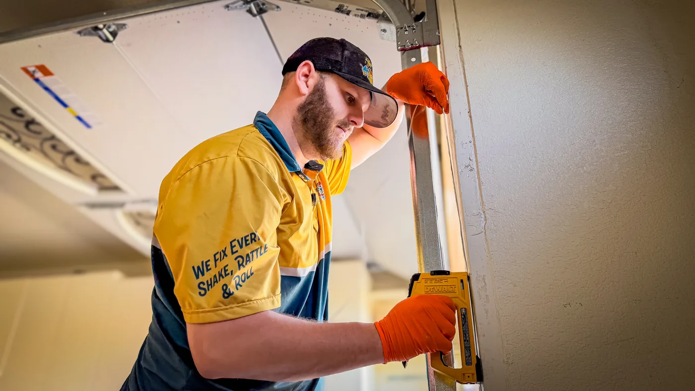 Las Vegas residential garage door technician leveling a door frame
