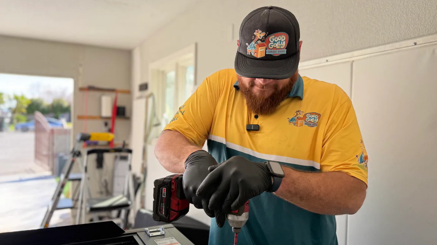Las Vegas residential garage door technician preparing tools during a door installation