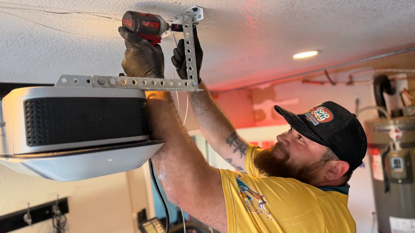 Las Vegas residential garage door technician installing an opener rail