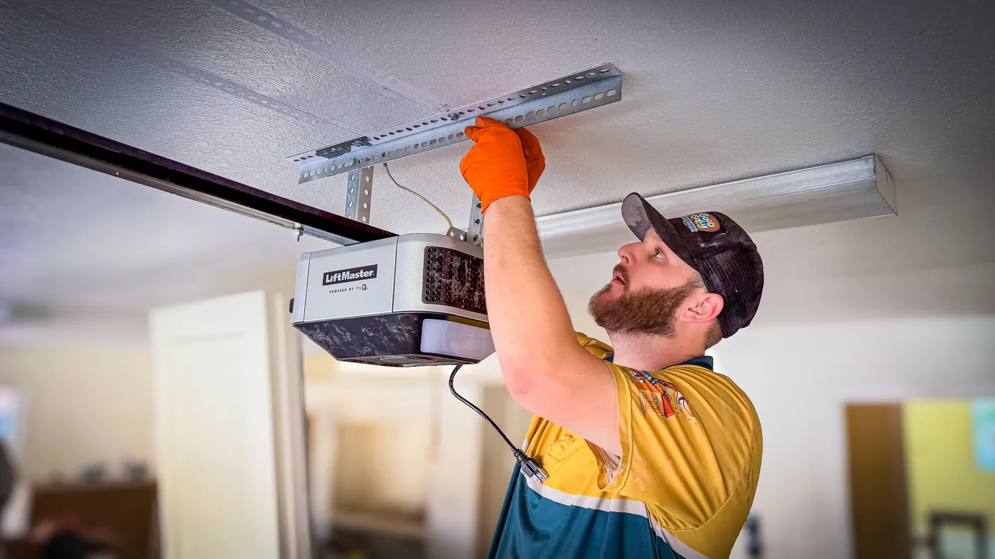 Las Vegas residential garage door technician servicing an overhead opener unit