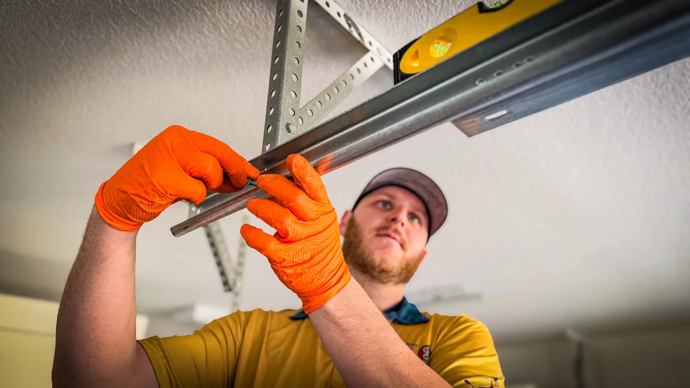 Las Vegas residential garage door technician working on an overhead door track
