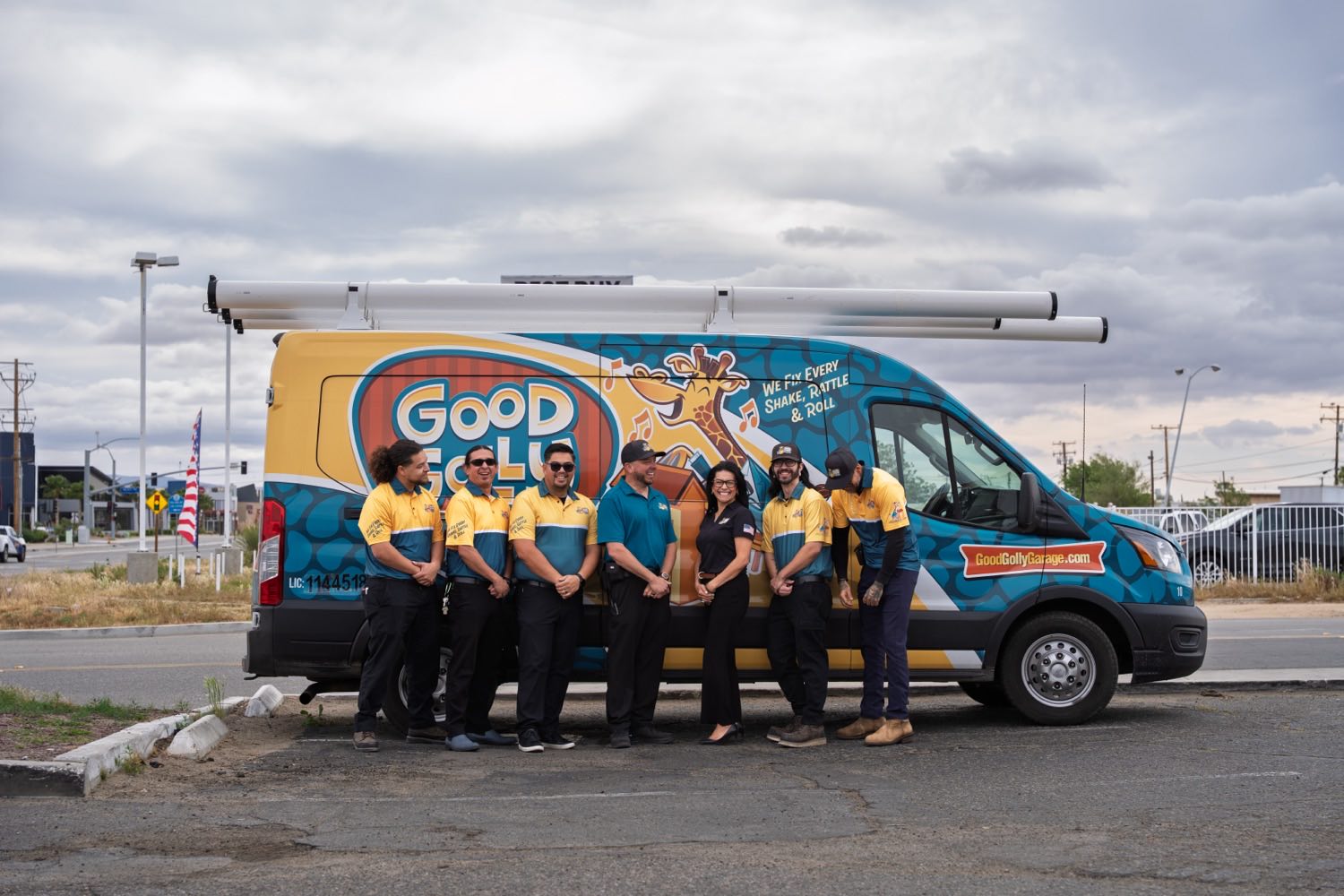 The Good Golly Garage Doors Victorville team lined up in front of their wrapped service van
