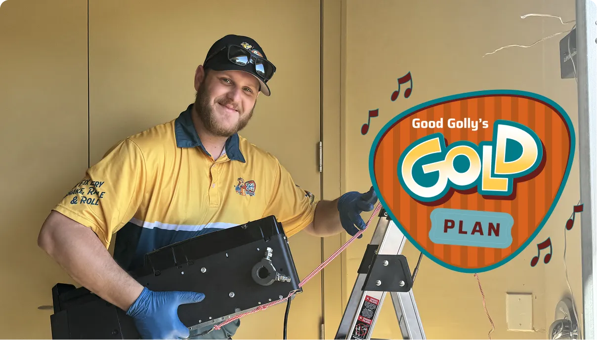 Good Golly technician carrying a garage door opener, with the Good Golly's Gold Plan badge