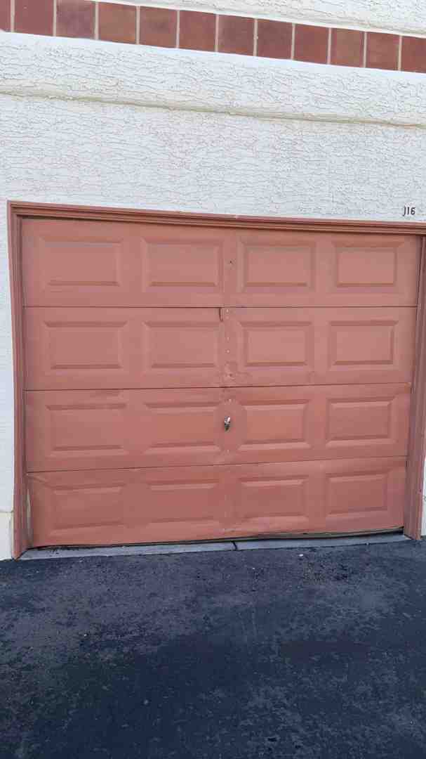 Sun damaged weatherstripping and faded garage door panels