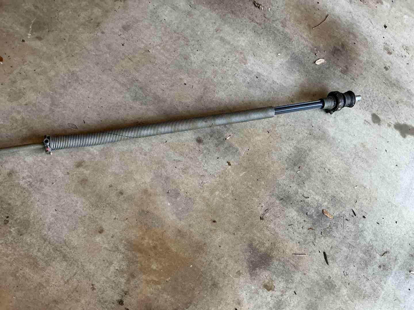 heavy-duty garage door spring assembly showing steel coils and winding cones