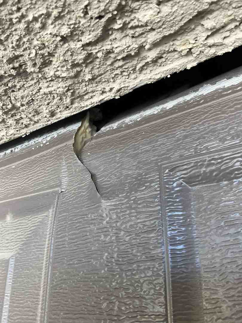 sagging garage door panel needing structural repair