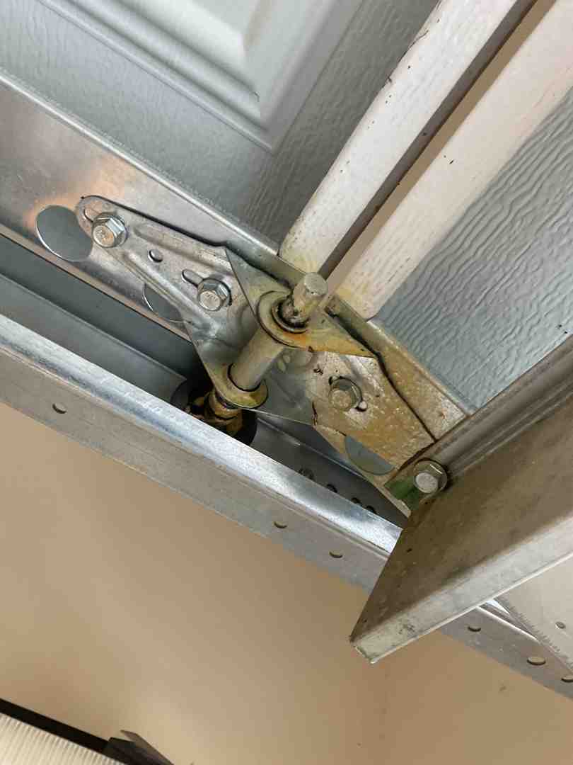 Garage door track filled with dust and lubricant buildup Garage door track filled with dust and lubricant buildup