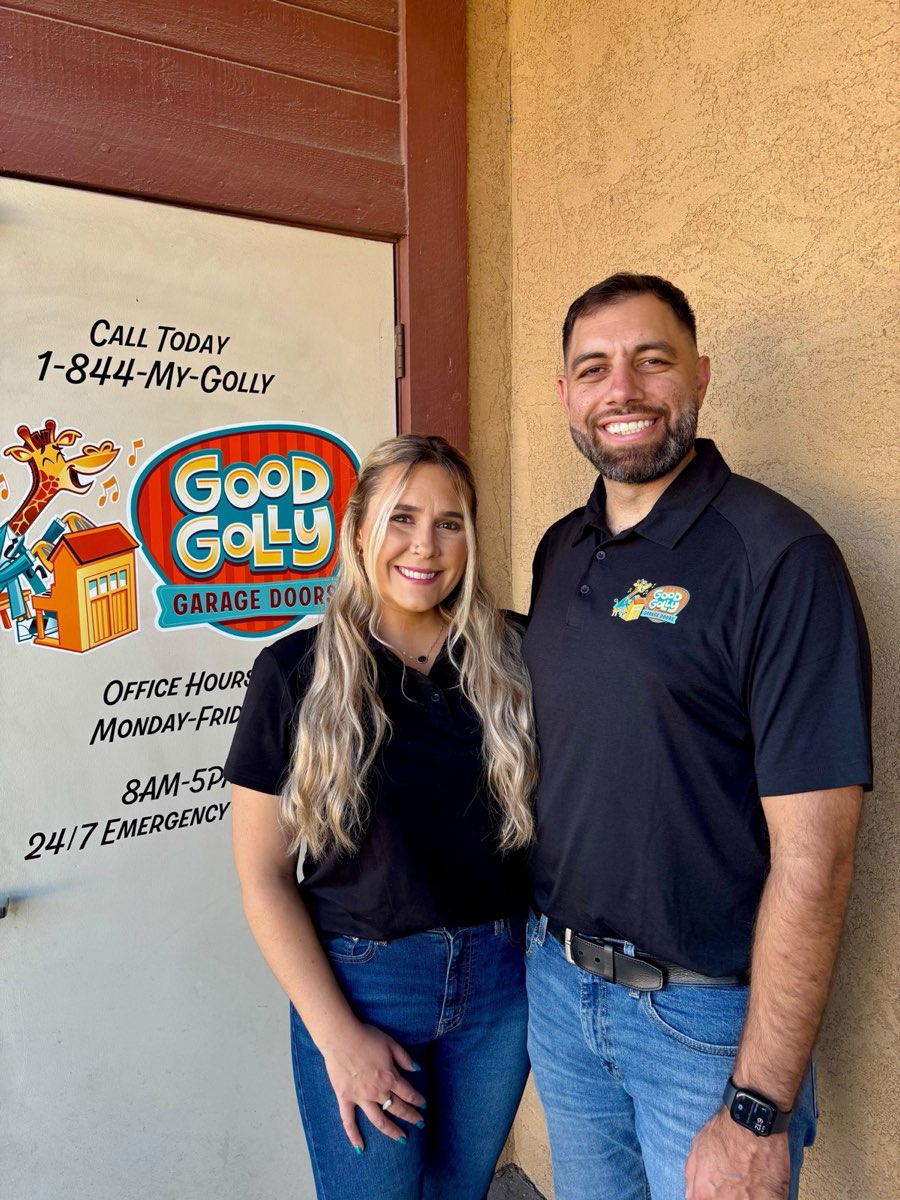 Roland and Alesha Serb at the door of the Good Golly Garage Doors Boise shop