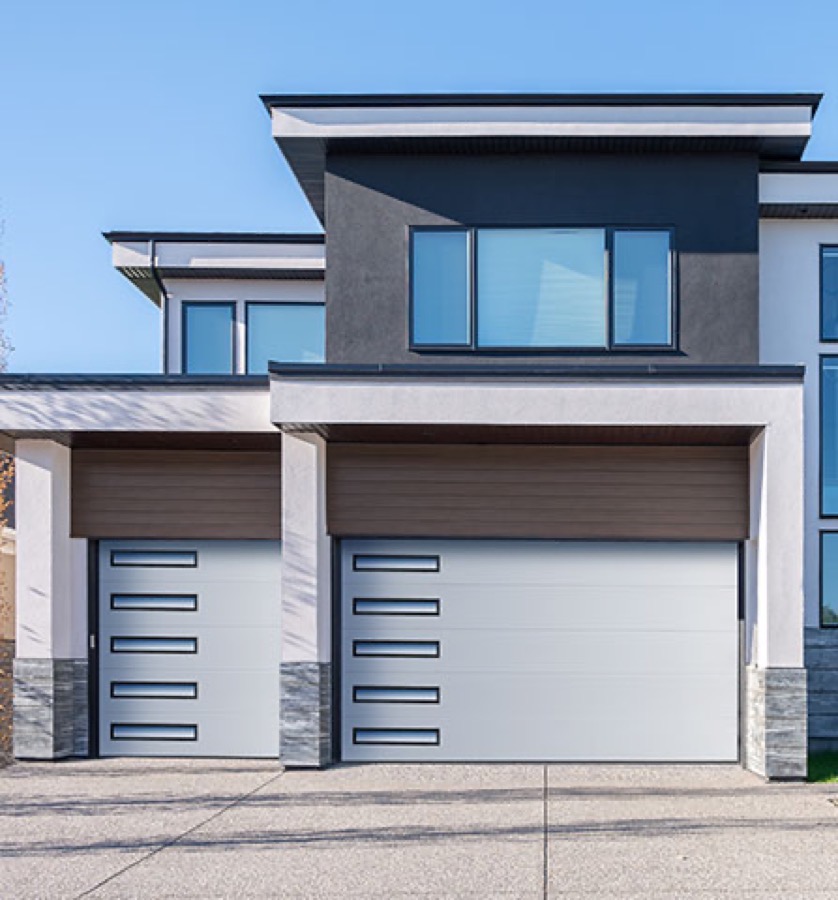 An Amarr EOS smooth flush-panel garage door with slimline glazing on a modern home
