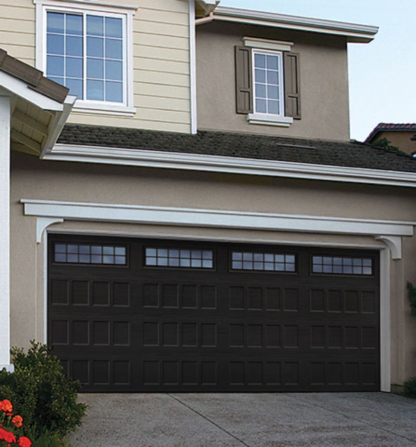 An Amarr recessed-panel steel garage door in black with a glazed top row