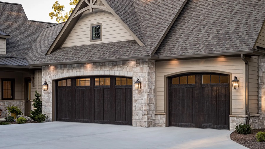 A Clopay Canyon Ridge faux-wood garage door with an arched window row in espresso