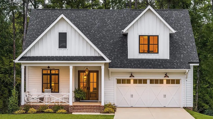 A Clopay Coachman carriage-house garage door on a modern farmhouse