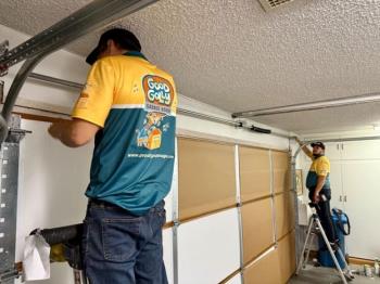 Good Golly Garage Doors technician repairing garage door in Anthem