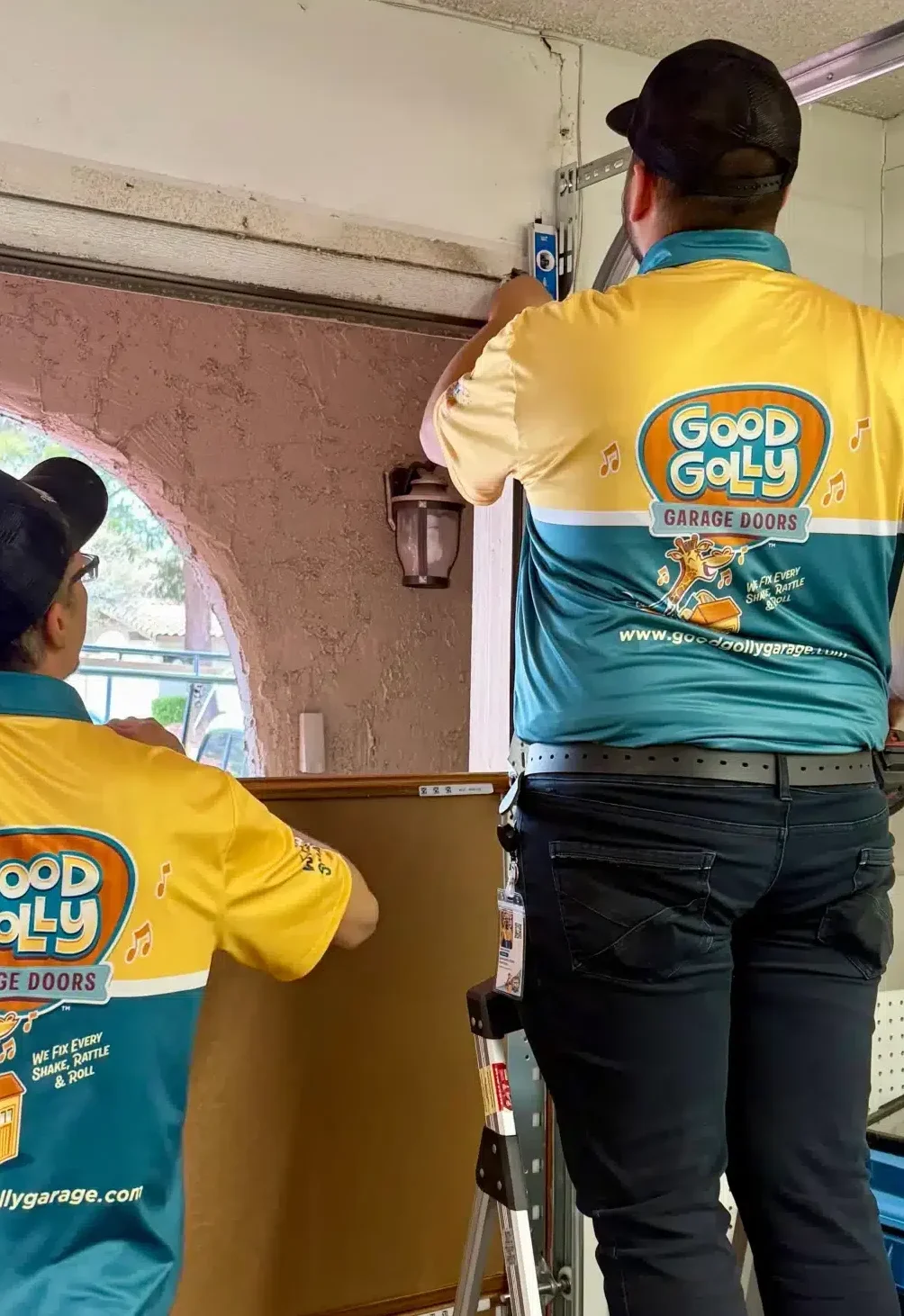 Good Golly Garage Doors technicians repairing residential garage in Las Vegas, NV.